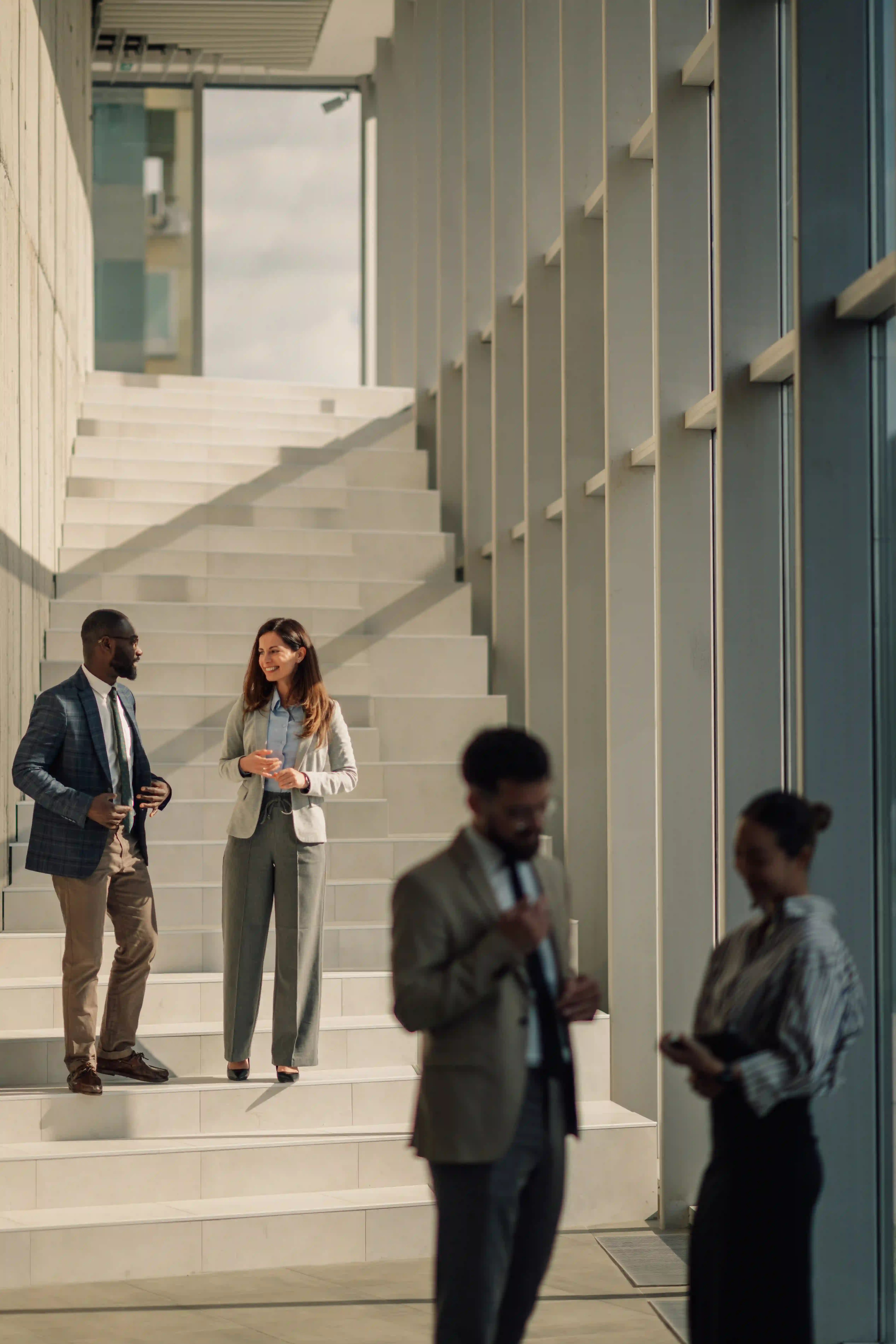 business-people-discussing-work-on-stairs-in-moder-2025-05-28-15-14-50-utc business-people-discussing-work-on-stairs-in-moder-2025-05-28-15-14-50-utc