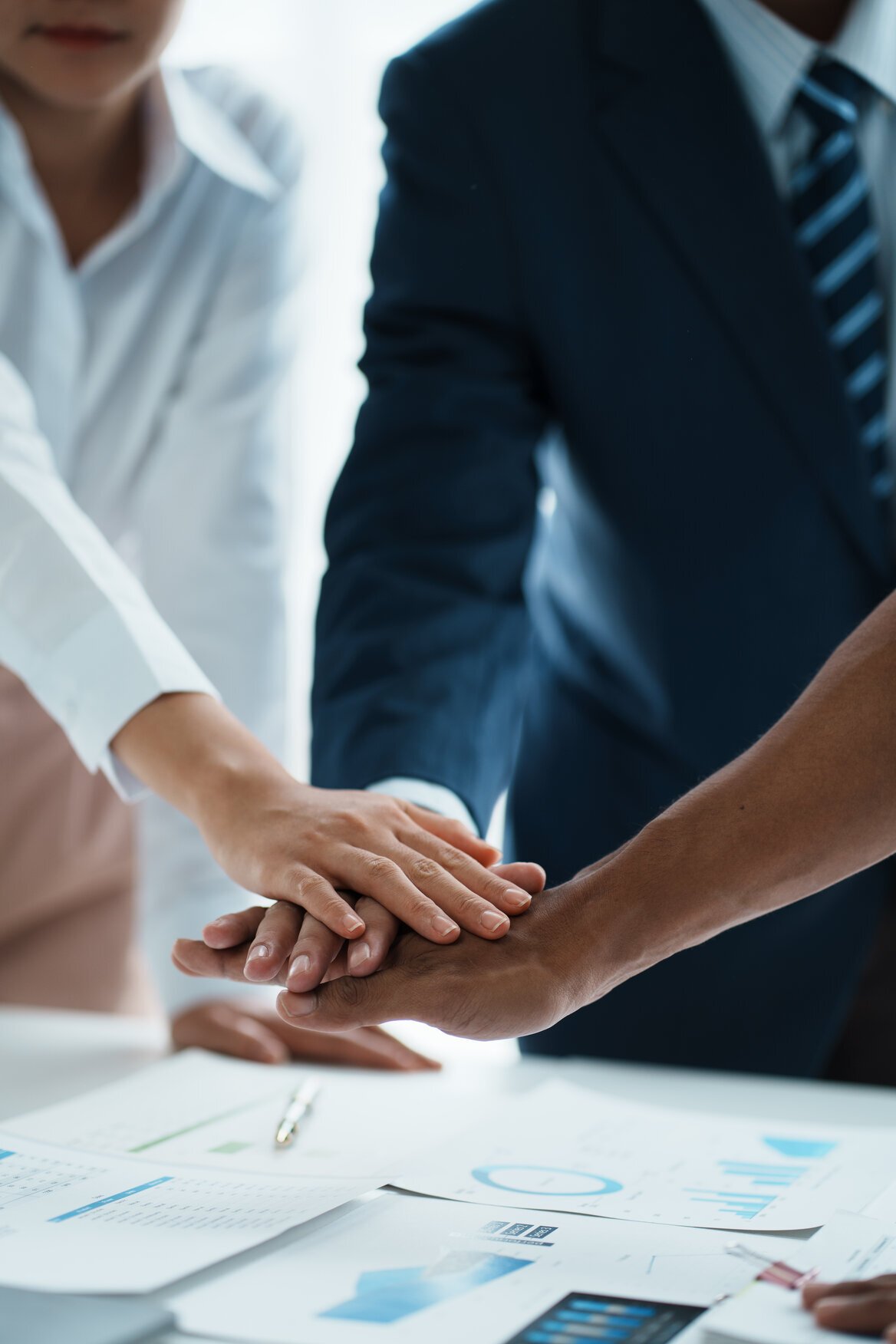 business people putting their hands together business people putting their hands together